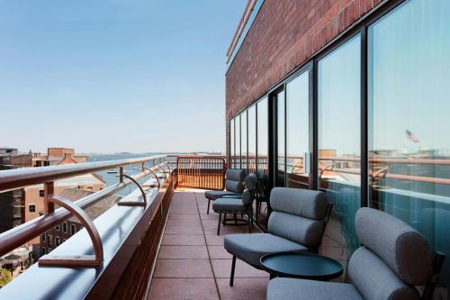 a balcony of a building with chairs and windows at Boston Marriott Long Wharf in Boston