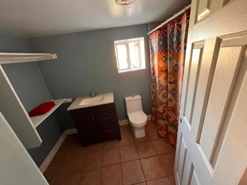 a small bathroom with a toilet and a sink at Downtown Secluded Room 2 in Phoenix