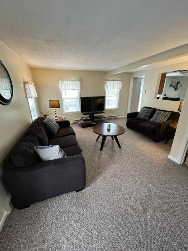 a living room with a couch and a table at Clayton Dahlia Retreat in Clayton