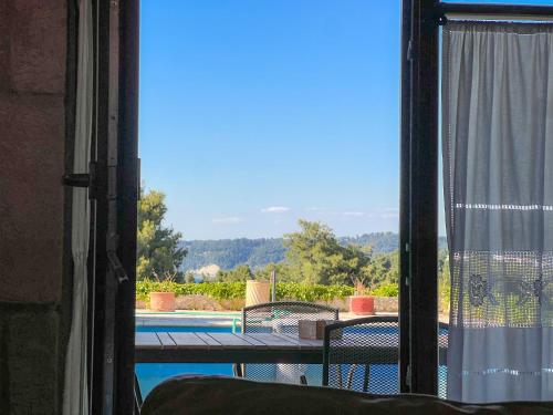 a view of a pool from a room with a window at Villa Posidi with Private Pool and Sea View in Possidi