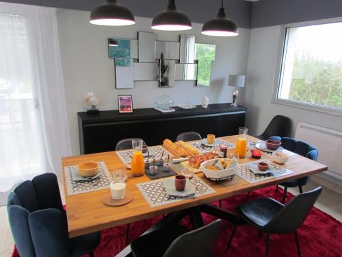 a dining room with a table with food on it at Kerwall - Maison d'hôtes in Malville