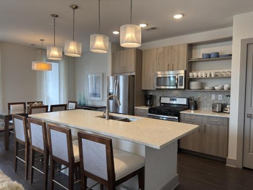 a kitchen with a large island in the middle of a room at The Pointe Unit 321 by 30A Escapes in Rosemary Beach
