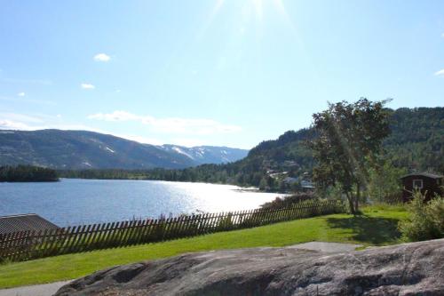 a view of a lake with mountains in the background at Nedre Strand Hytteutleie in Vradal