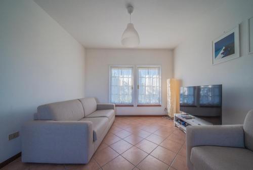 a living room with two couches and a tv at Conero Cottage in Porto Recanati