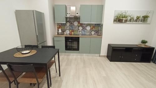 a kitchen with a table and a dining room at Gelsonero Apartments in Ragalna