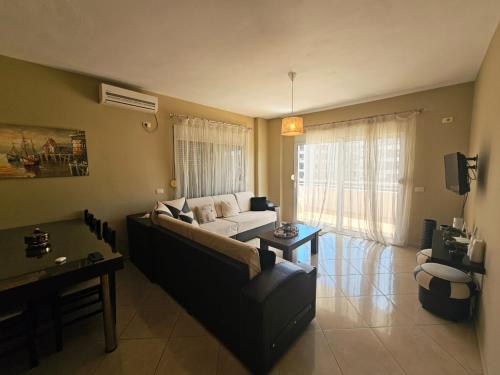 a living room with a couch and a table at Sion Sarande Apartments in Sarandë