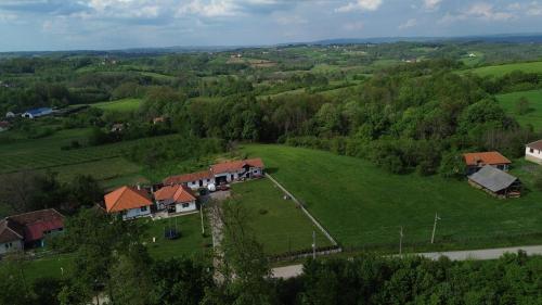 an aerial view of a house in a green field at Kuća za odmor Vasiljević in Milavac