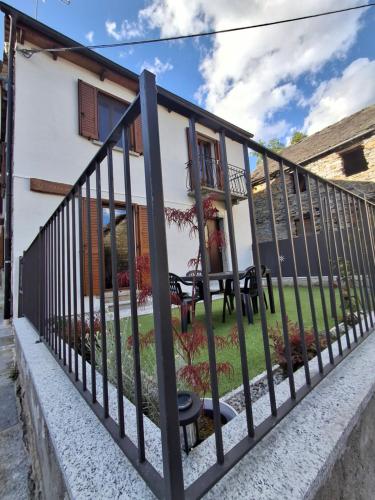 a black fence in front of a house at Casa Jedi in Santa Maria Maggiore