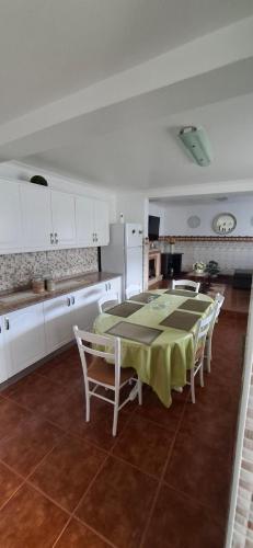 a kitchen with a table and chairs in a room at Casa Santos in Angra do Heroísmo