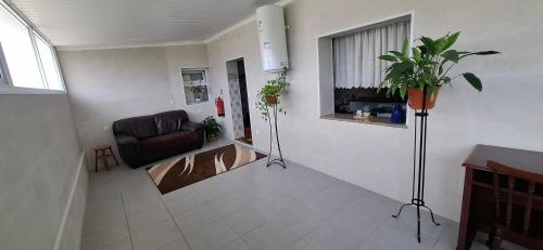 a living room with a couch and a window at Casa Santos in Angra do Heroísmo