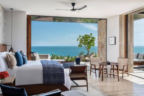 a bedroom with a bed and a view of the ocean at Zadún, a Ritz-Carlton Reserve, Los Cabos in San José del Cabo