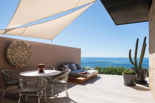 a patio with a table and chairs and a couch at Zadún, a Ritz-Carlton Reserve, Los Cabos in San José del Cabo