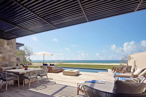 an outdoor patio with a view of the ocean at Zadún, a Ritz-Carlton Reserve, Los Cabos in San José del Cabo