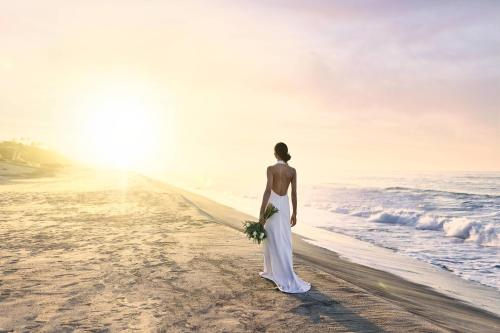 a woman standing on the beach looking at the ocean at Zadún, a Ritz-Carlton Reserve, Los Cabos in San José del Cabo