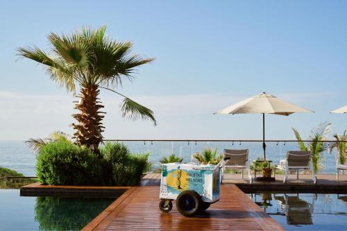 a food cart sitting on a dock next to the water at Zadún, a Ritz-Carlton Reserve, Los Cabos in San José del Cabo