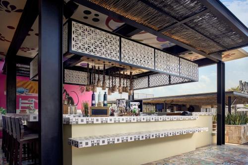 a restaurant with a bar with a counter at Zadún, a Ritz-Carlton Reserve, Los Cabos in San José del Cabo