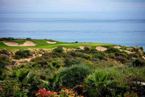 a golf course with the ocean in the background at Zadún, a Ritz-Carlton Reserve, Los Cabos in San José del Cabo