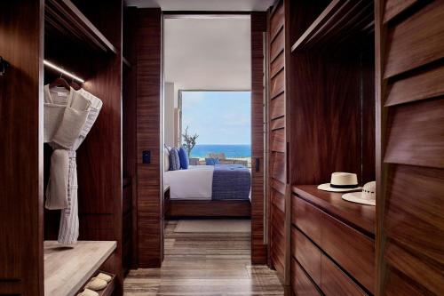a bedroom with a bed and a view of the ocean at Zadún, a Ritz-Carlton Reserve, Los Cabos in San José del Cabo