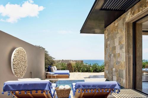 an outdoor patio with chairs and a view of the ocean at Zadún, a Ritz-Carlton Reserve, Los Cabos in San José del Cabo