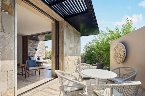 an outdoor patio with a white table and chairs at Zadún, a Ritz-Carlton Reserve, Los Cabos in San José del Cabo