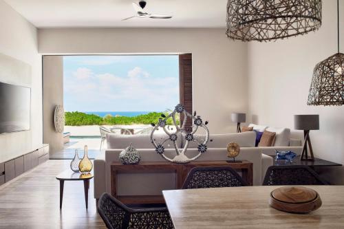 a living room with a couch and a chandelier at Zadún, a Ritz-Carlton Reserve, Los Cabos in San José del Cabo