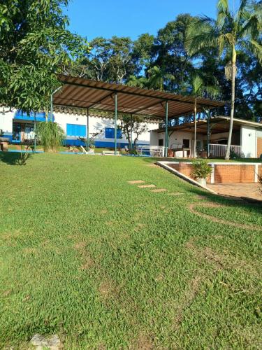 a large grass field with a building in the background at Exclusivo Haras Marilu! in Atibaia