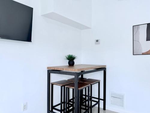 a table with a potted plant sitting on top of it at Renzzi Villas in Miami