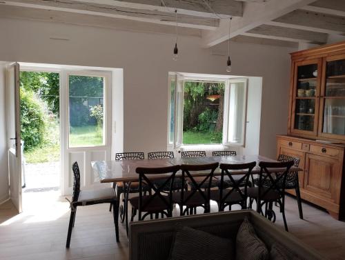 une salle à manger avec une table et des chaises dans l'établissement Charmante maison de centre bourg avec jardin, à Saint-Sozy