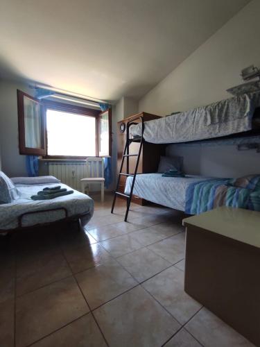 a bedroom with two bunk beds and a window at Green House in Rocca di Botte