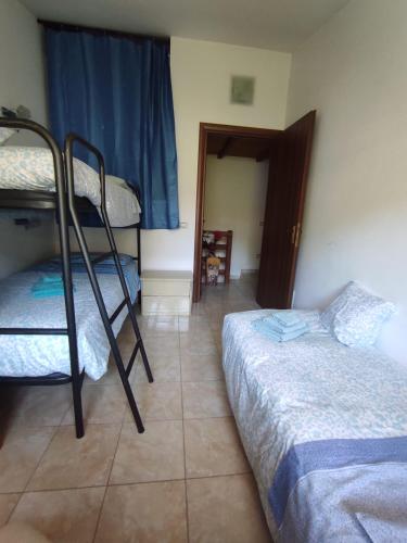 a bedroom with two bunk beds and a doorway at Green House in Rocca di Botte