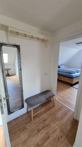 a room with a bench in front of a mirror at Ferienwohnung Bettmatten in Ettenheim