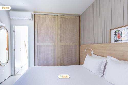 a bedroom with a white bed and a window at Casa com Piscina no Origem Fortim in Fortim