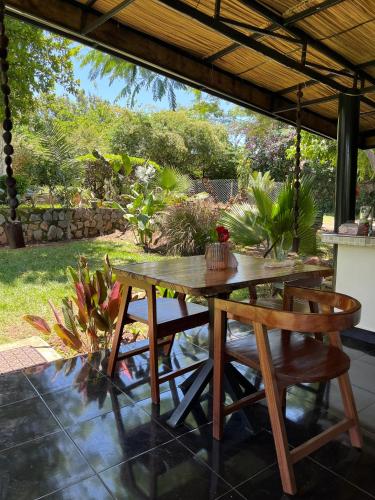 a wooden table and chairs on a patio at PachobyDaisy in Awasi