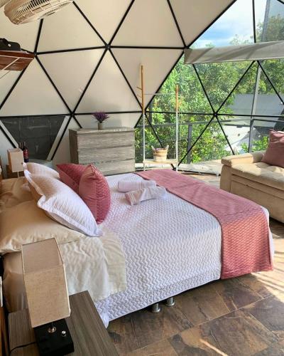 a bedroom with a bed in a tent at Eco Boutique-Naranjo in La Vega