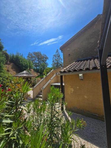 - une vue sur un bâtiment avec des escaliers et des plantes dans l'établissement La Croix-Valmer, La ferme, Le Vergeron, entre terre et mer, à La Croix-Valmer