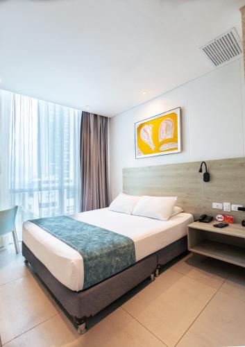 a hotel room with a bed and a window at Hotel Zi One Luxury in Cartagena de Indias