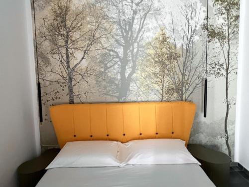 a bed with an orange headboard in a room at Nova Domus in Trapani