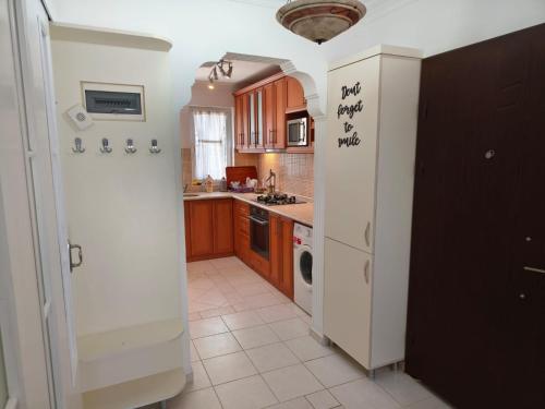 a kitchen with a sink and a stove top oven at Villa Yelken Oludeniz in Ovacik