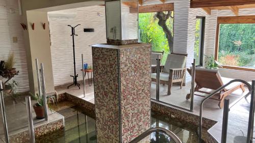 a kitchen with a brick fireplace in a house at Casa Alta Hotel Boutique & Spa - Solo Adultos in Villa Carlos Paz