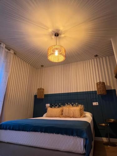 a bedroom with a bed and a chandelier at Casal de pelaio in Barreiros