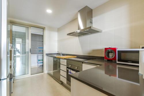 a kitchen with a red appliance on a counter at Casita San Juan in Pilar de Jaravía