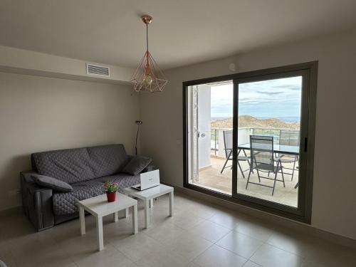a living room with a couch and a table at Casita San Juan in Pilar de Jaravía