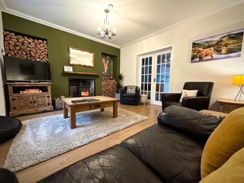a living room with a couch and a coffee table at Wells Street Cottages No 26 By The River Ness in Inverness