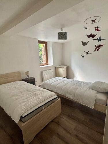 Postel nebo postele na pokoji v ubytování La Maison du Ruisseau