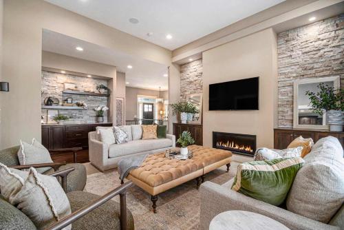 a living room with a couch and a fireplace at Luxury Stay with Golf Simulator and 3 King Bedrooms in Elkhorn