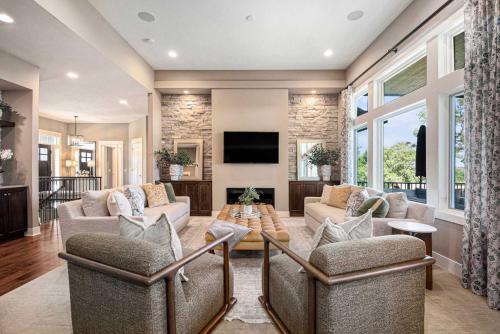 a living room with two couches and a tv at Luxury Stay with Golf Simulator and 3 King Bedrooms in Elkhorn
