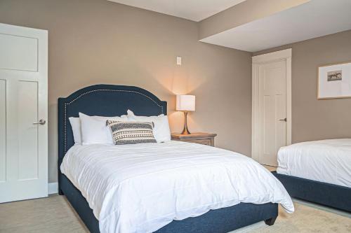 a bedroom with a bed with a blue headboard at Luxury Stay with Golf Simulator and 3 King Bedrooms in Elkhorn