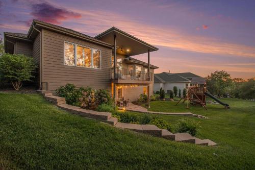 a house with a staircase leading up to it at Luxury Stay with Golf Simulator and 3 King Bedrooms in Elkhorn