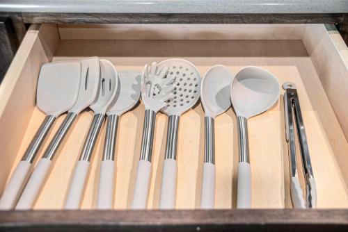 a drawer with a bunch of utensils in it at Luxury Stay with Golf Simulator and 3 King Bedrooms in Elkhorn