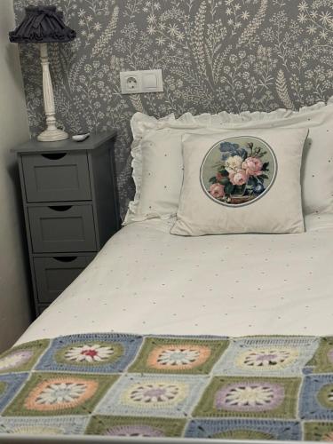 a bedroom with a bed with a pillow and a night stand at Cueva Colorin Alloza. in Alloza